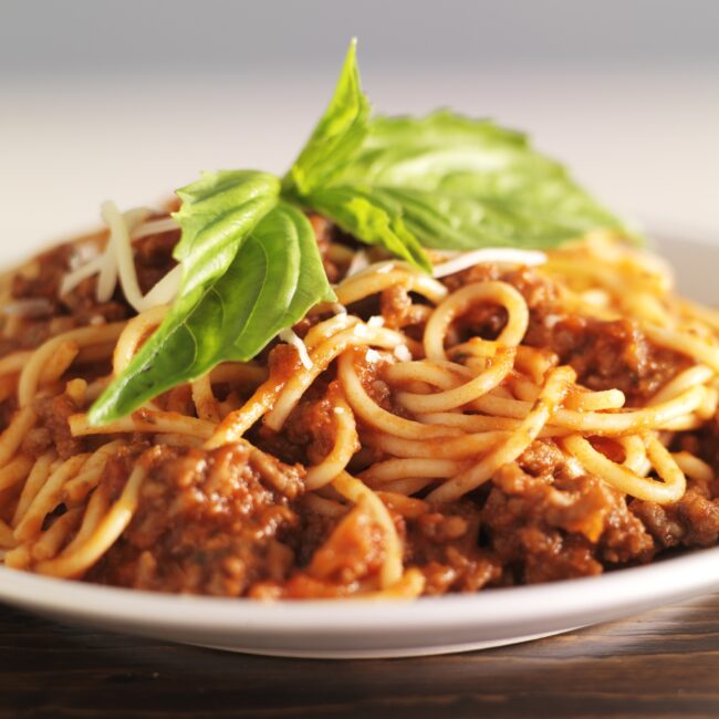 plate full of spaghetti and meat sauce
